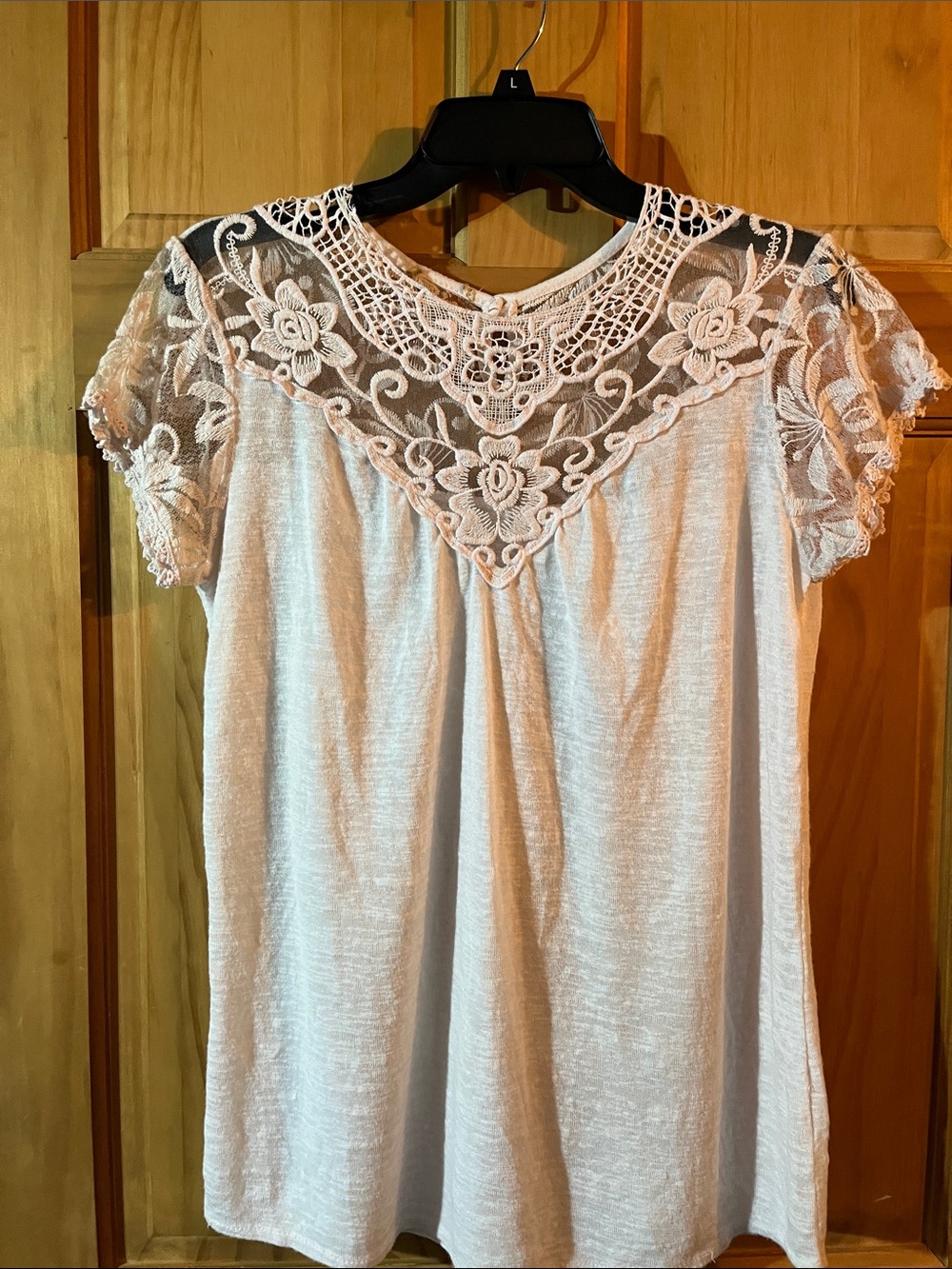 Women’s Cream blouse with lace neck and sleeves.